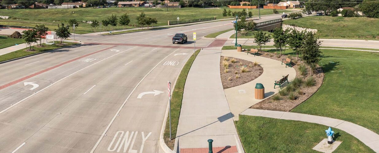 road by grassy fields and trail by North Colony Boulevard